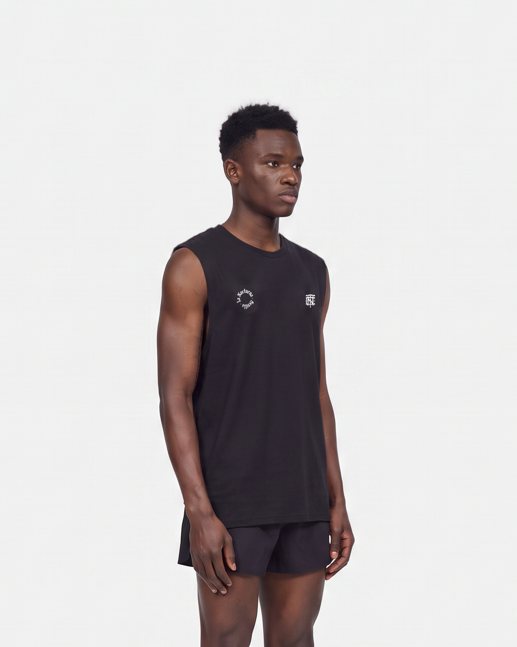 Model wearing the Let's Run the Night tank top in black — three-quarter view, close crop on the regular fit — View 5