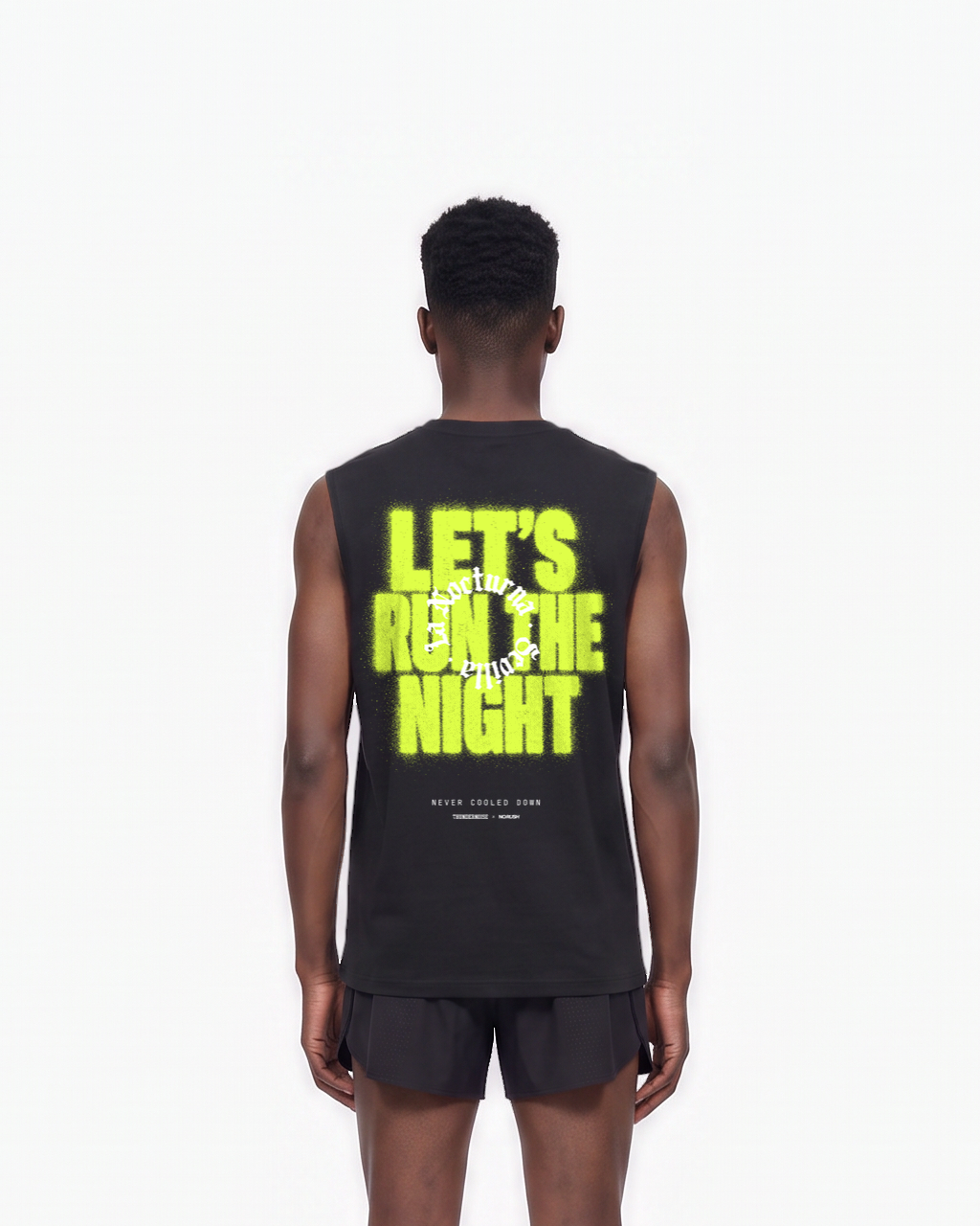 Model wearing the Let's Run the Night tank top in black — back view, close crop on LET'S RUN THE NIGHT sprayed in electric lime around the La Nocturna Sevilla seal — View 7