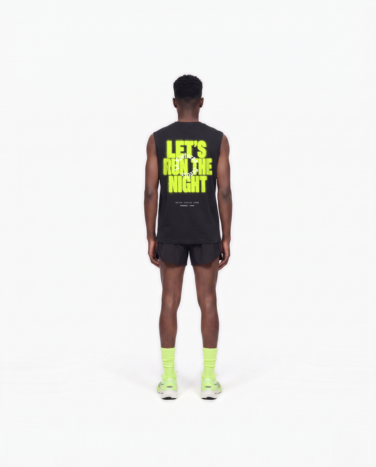 Model wearing the Let's Run the Night tank top in black — back view with LET'S RUN THE NIGHT sprayed in electric lime around the La Nocturna Sevilla seal — View 6