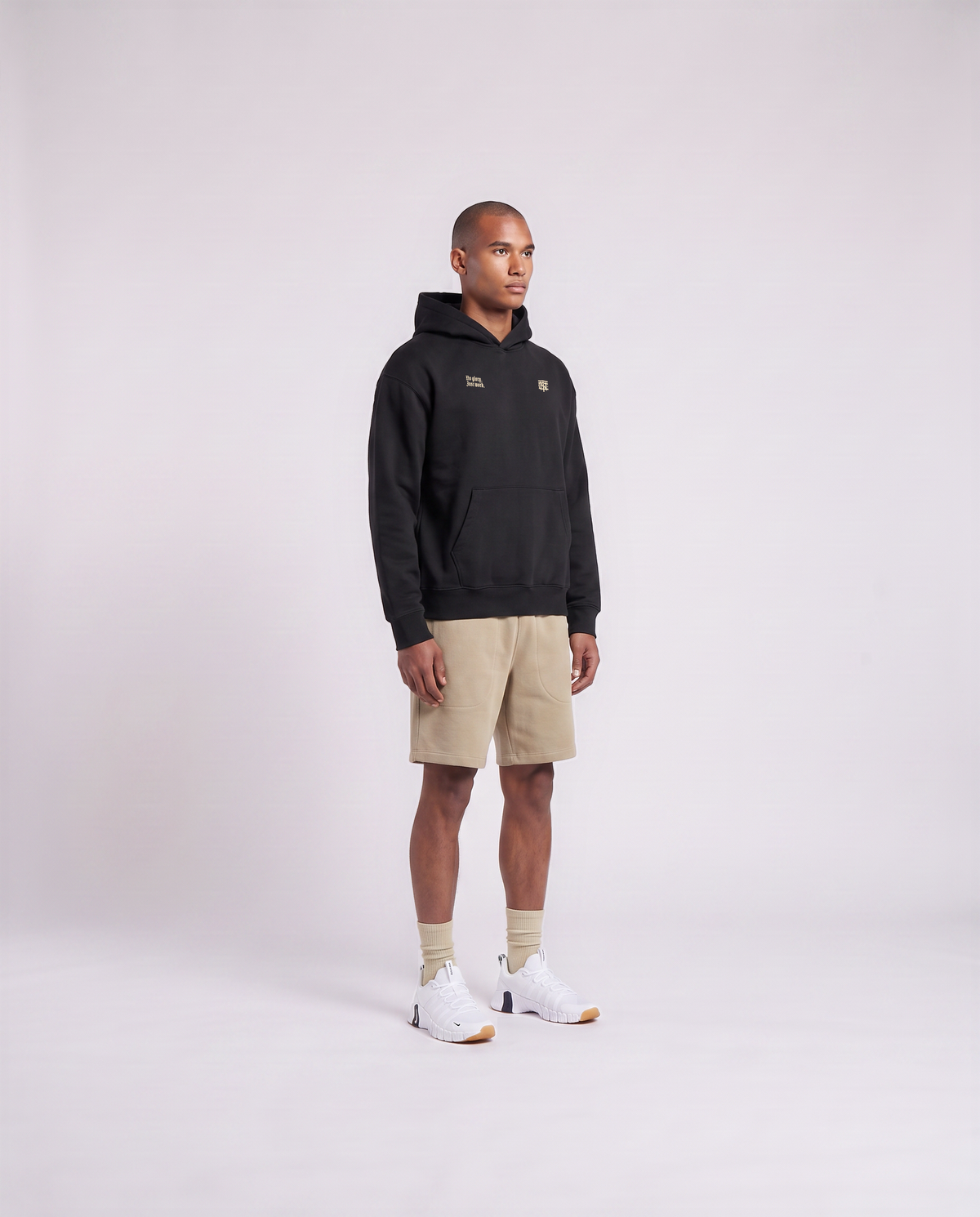 Model wearing the No Glory Just Work oversize hoodie in black — three-quarter view showing the oversize fit — View 3