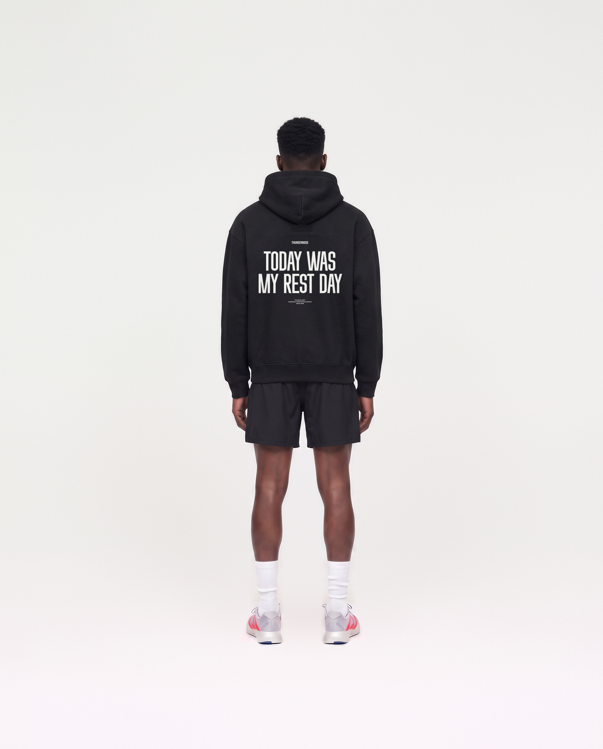 Model wearing the Today Was My Rest Day oversize hoodie in black — back view with the TODAY WAS MY REST DAY block in white — View 4