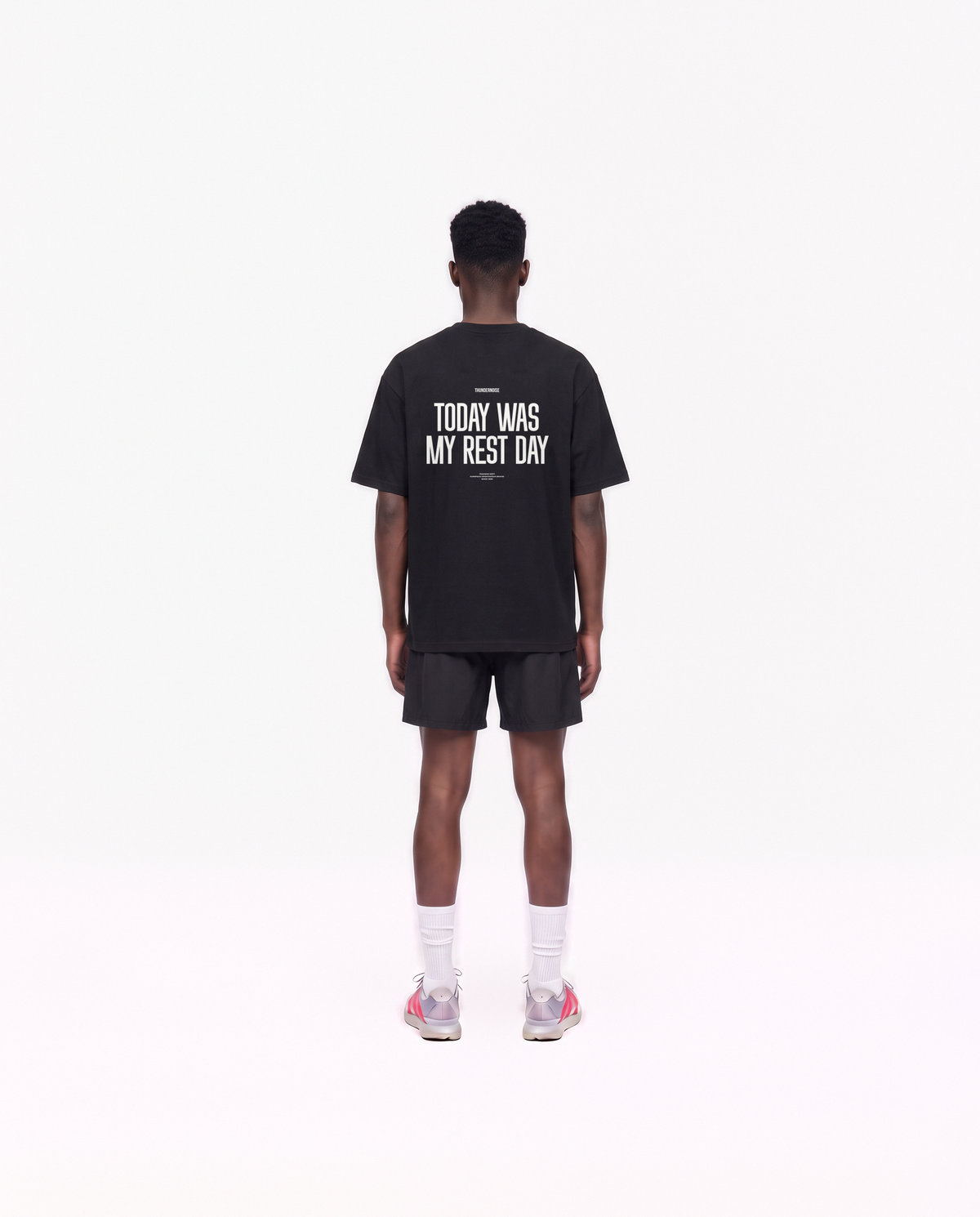 Model wearing the Today Was My Rest Day oversize t-shirt in black — back view with the TODAY WAS MY REST DAY block in white — View 4