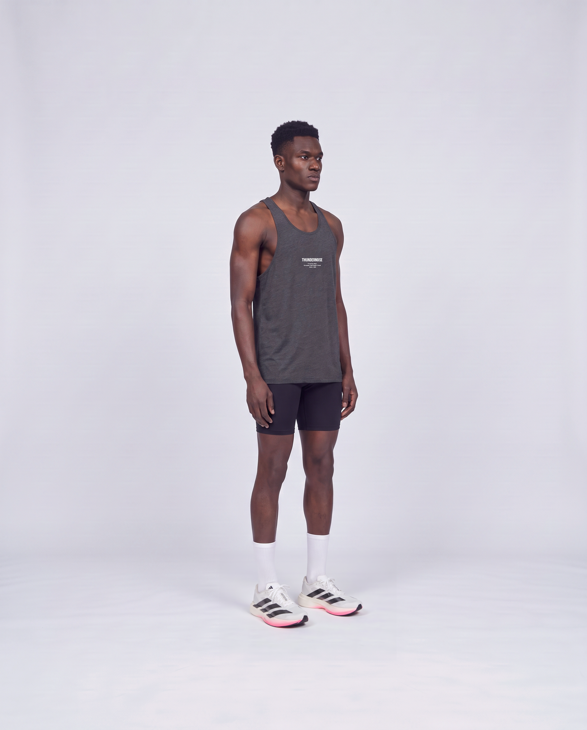 Training Dept. triblend tank top in dark grey heather on model — three-quarter view — View 3