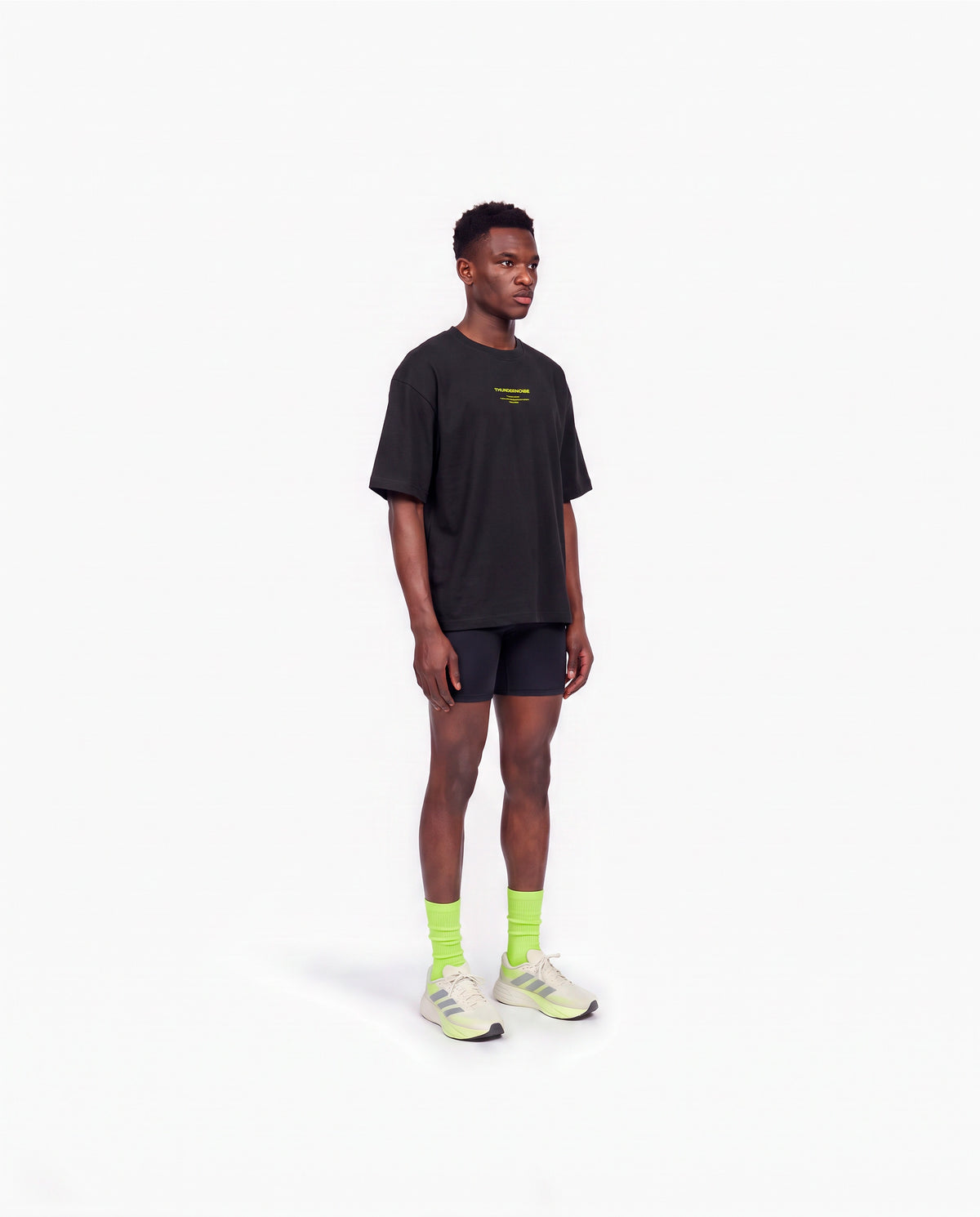 Model wearing the Brick by Brick oversize t-shirt in black — three-quarter view showing the oversize fit — View 3
