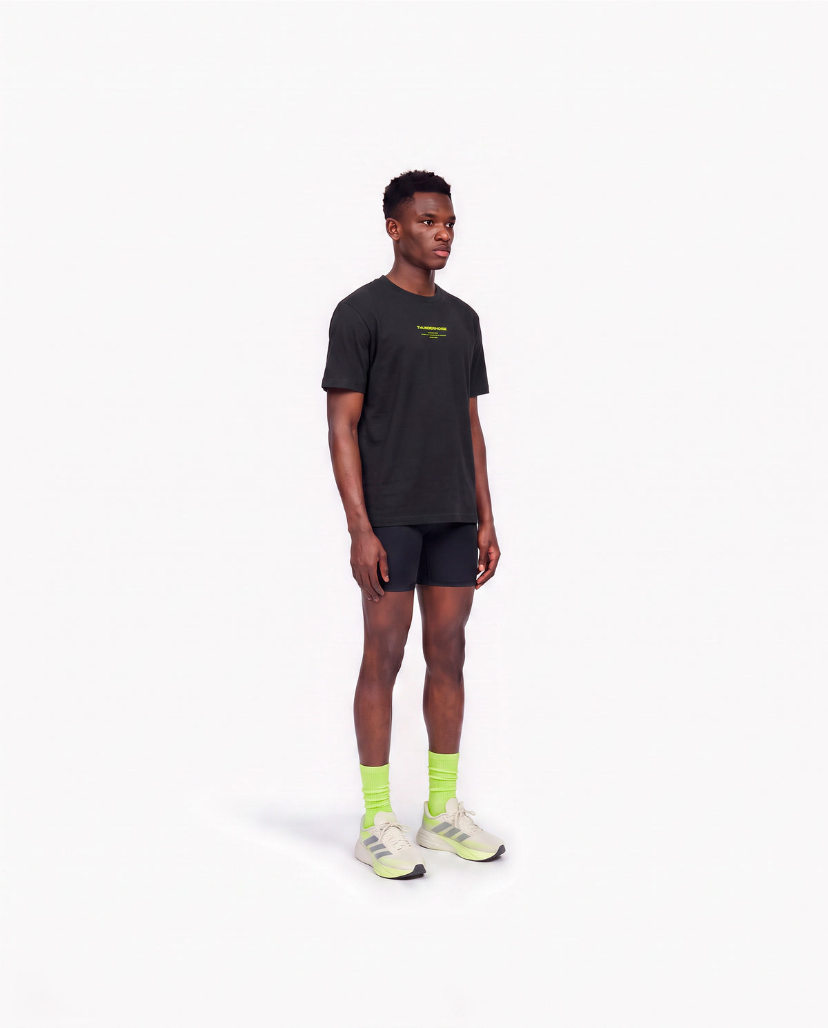 Model wearing the Brick by Brick t-shirt in black — three-quarter view showing the regular fit — View 3
