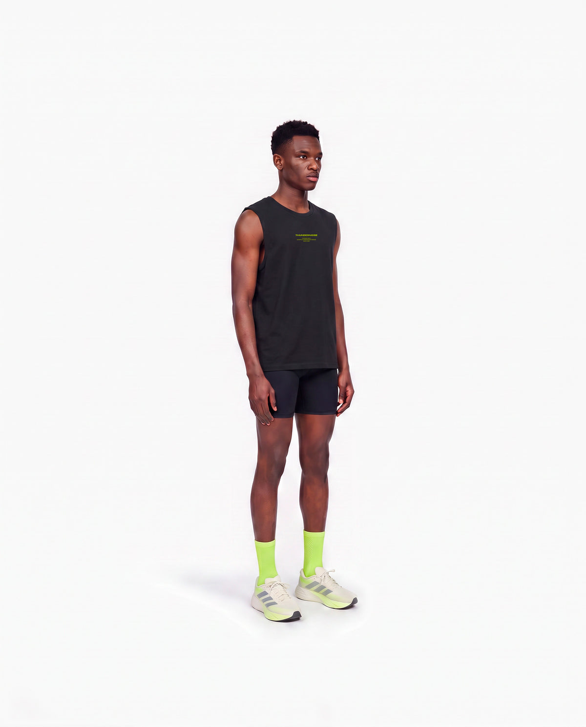 Model wearing the Brick by Brick tank top in black — three-quarter view showing the regular fit — View 3

