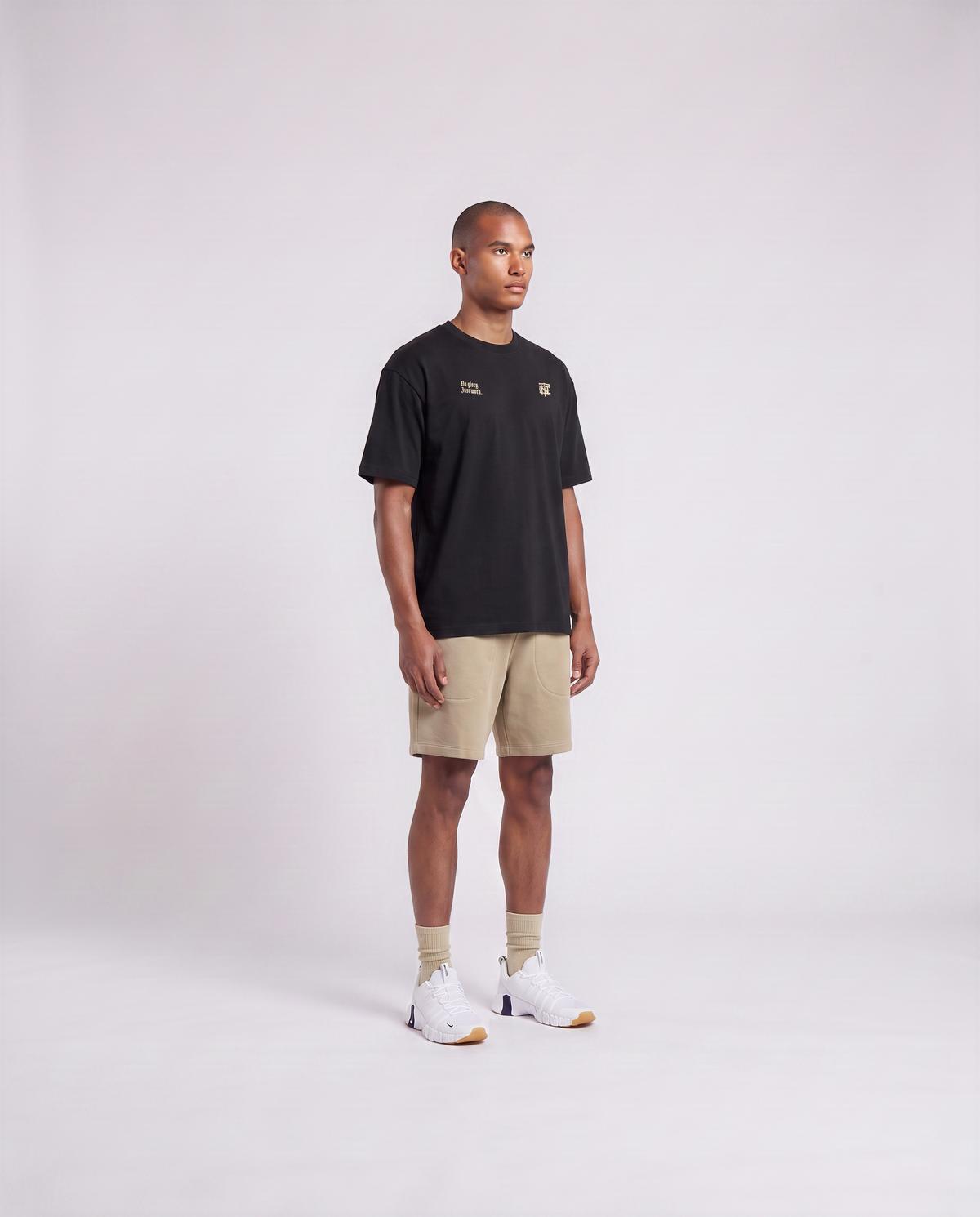 Model wearing the No Glory Just Work oversize t-shirt in black — three-quarter view showing the oversize fit — View 3
