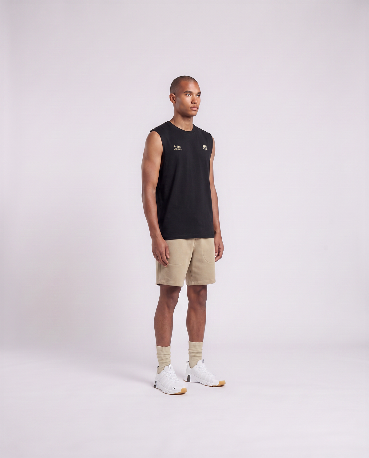 Model wearing the No Glory Just Work tank top in black — three-quarter view showing the regular fit — View 3
