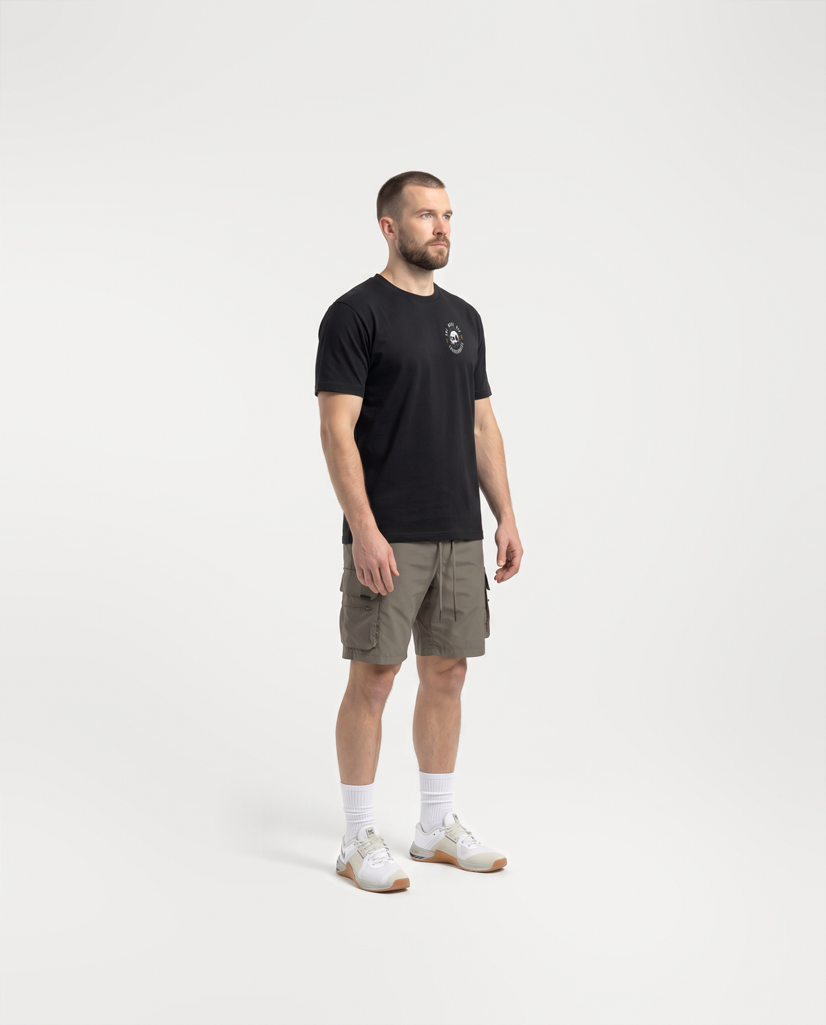 Model wearing the One More Rep t-shirt in black — three-quarter view showing the regular fit — View 3
