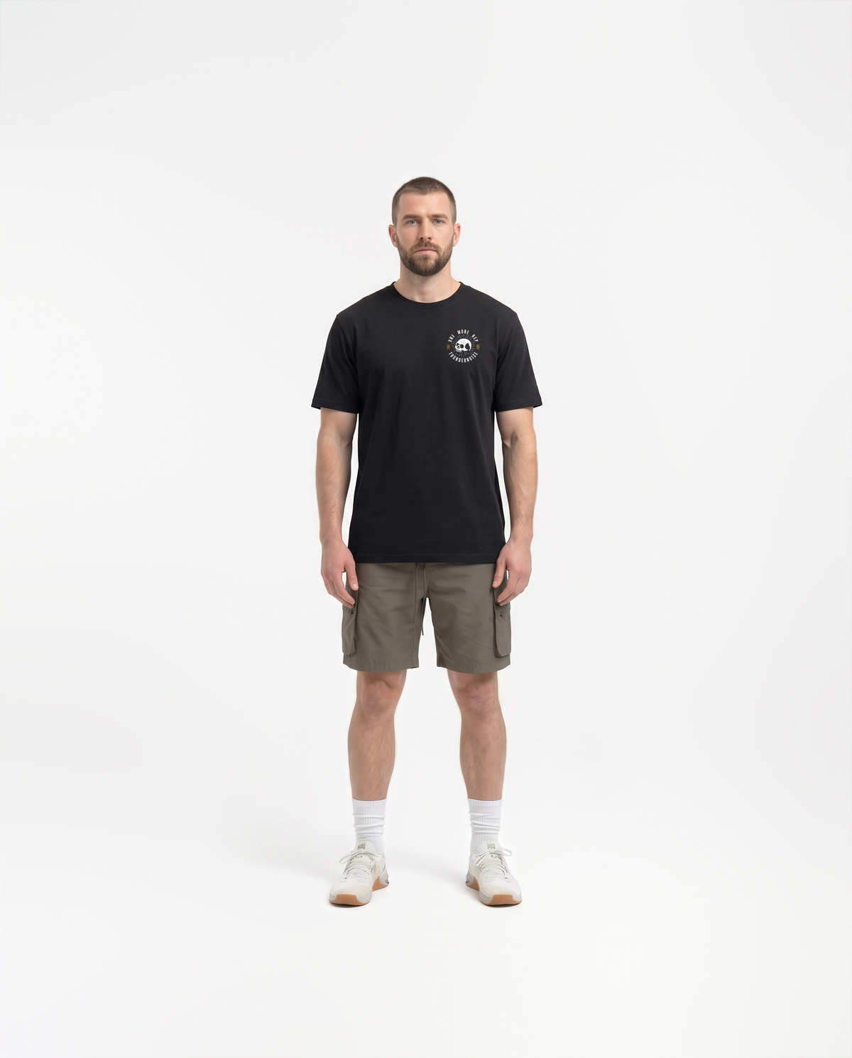 Model wearing the One More Rep t-shirt in black — front view with the halftone skull seal ringed by ONE MORE REP at the left chest — View 2

