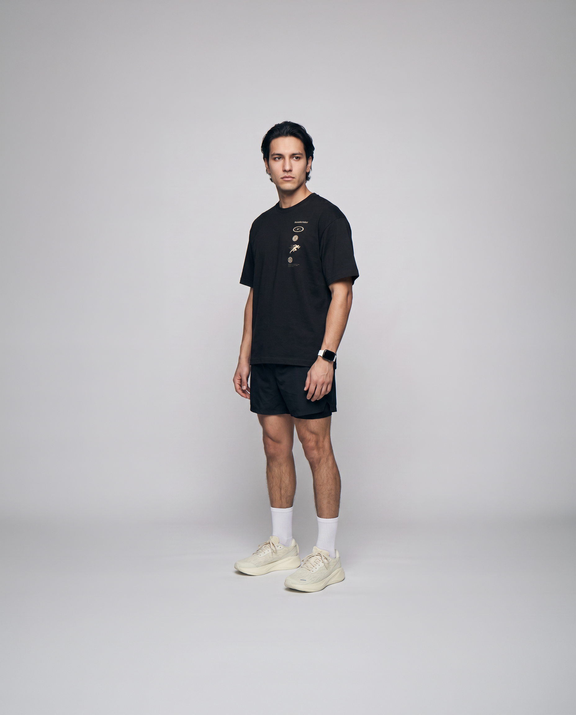 Model wearing the Strong Enough to Run oversize t-shirt in black — three-quarter view showing the oversize fit