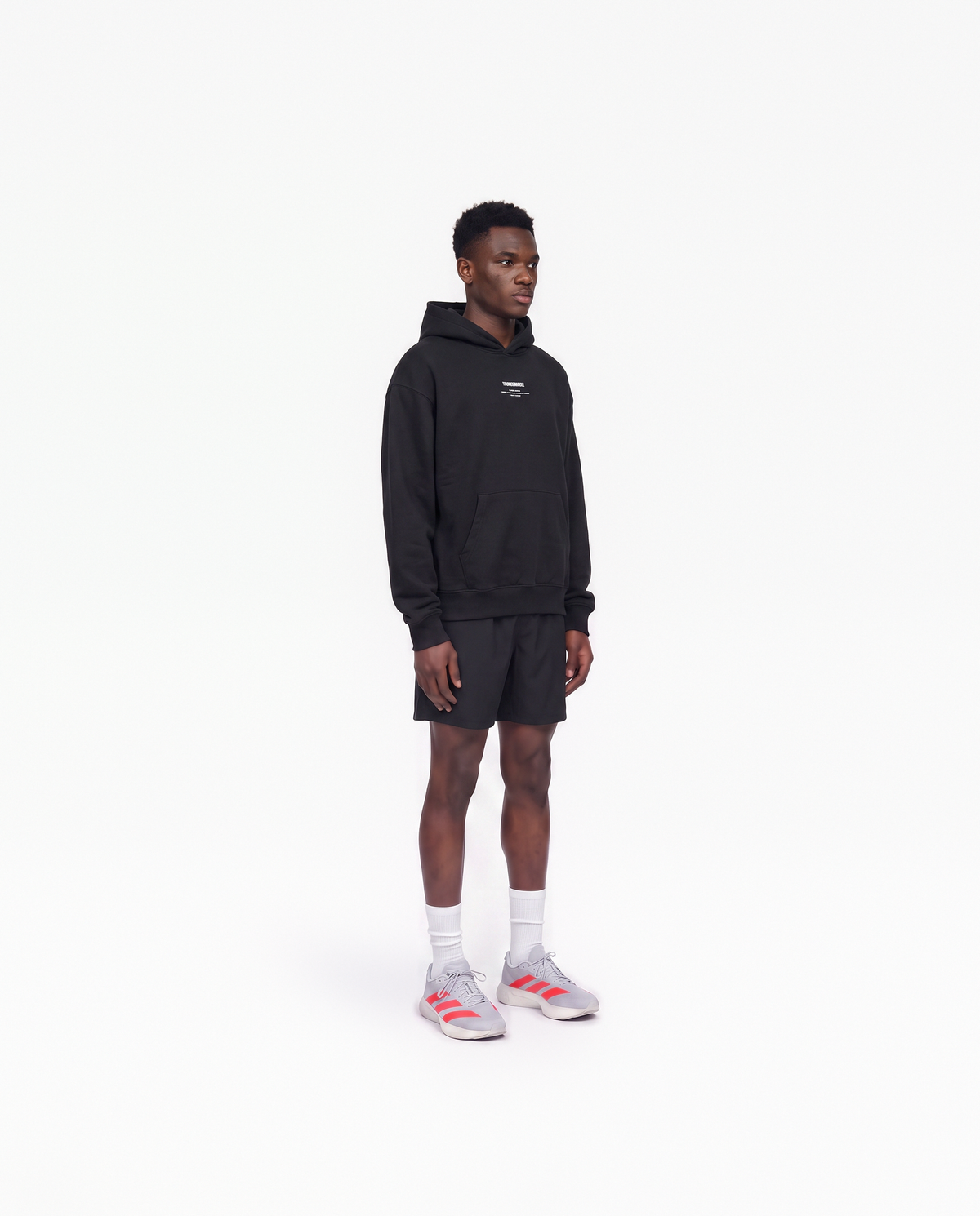 Model wearing the Today Was My Rest Day oversize hoodie in black — three-quarter view showing the oversize fit — View 3

