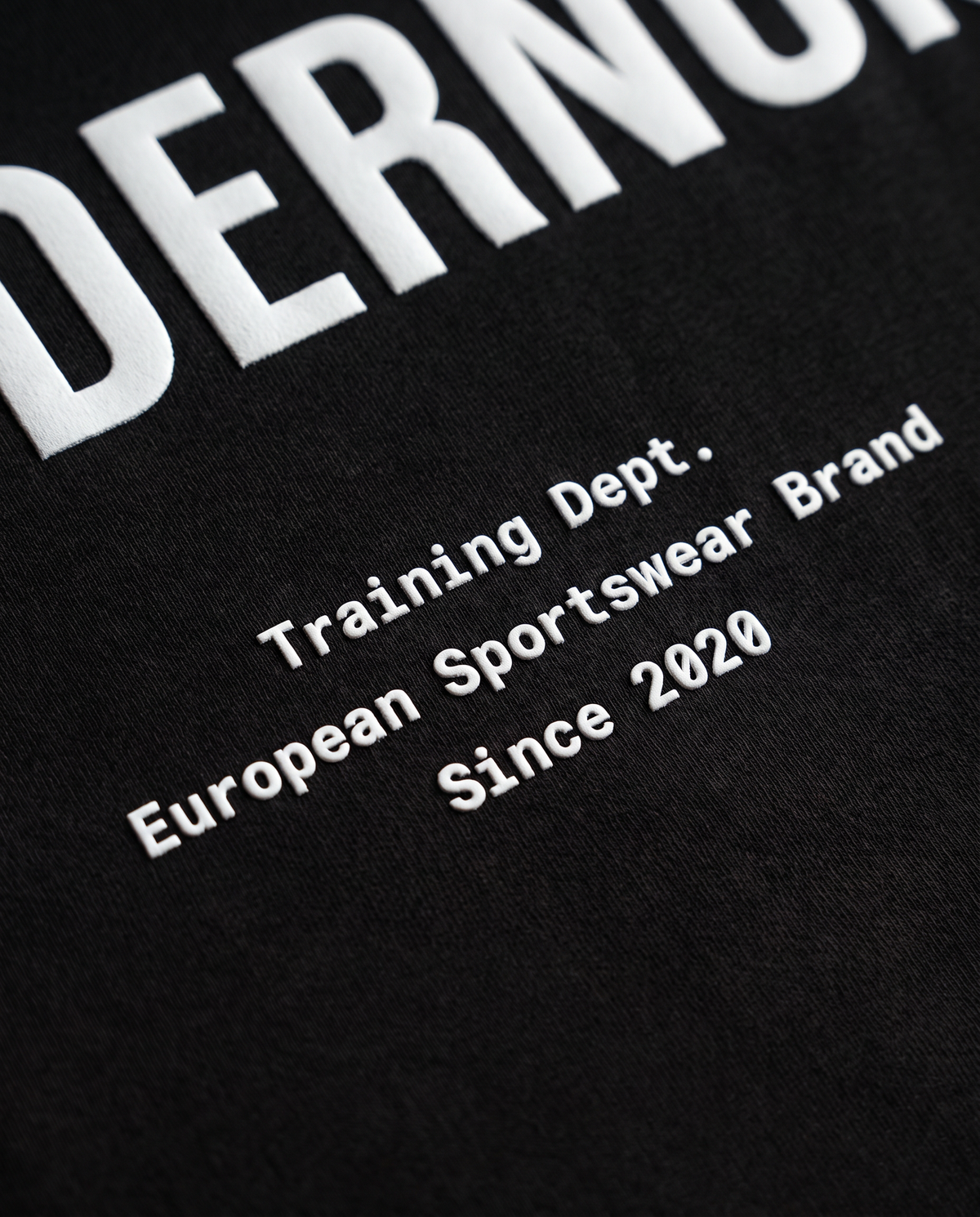 Training Dept. triblend cropped t-shirt in black — close-up of the raised high-density print on the back — View 5
