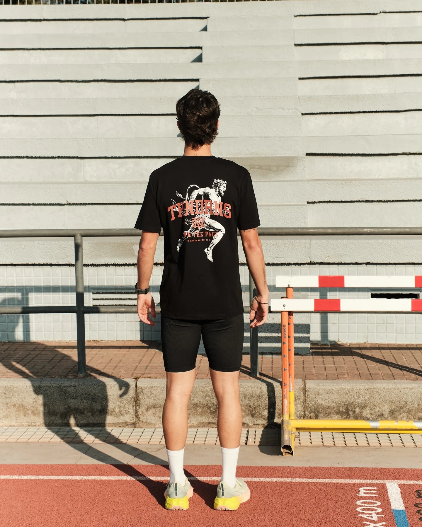 Athlete wearing a Thundernoise Legacy Runner tank on a running track